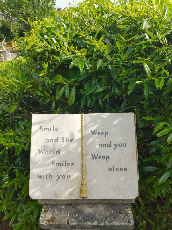A carved stone book with inscribed quotation