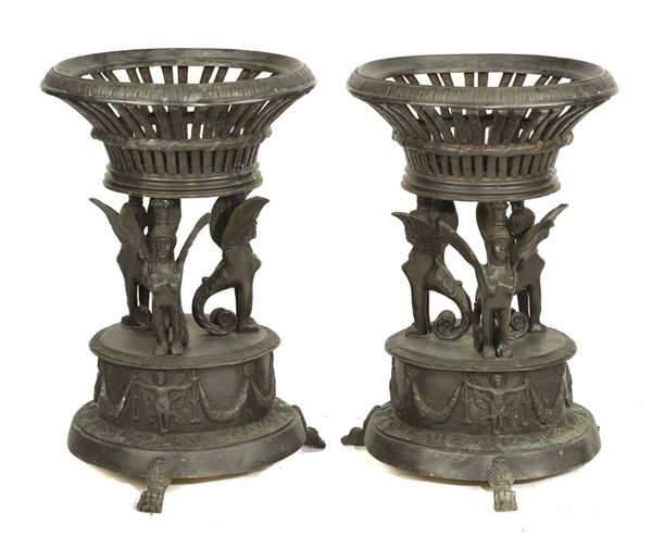 A pair of bronze Pompeian style jardiniere stands