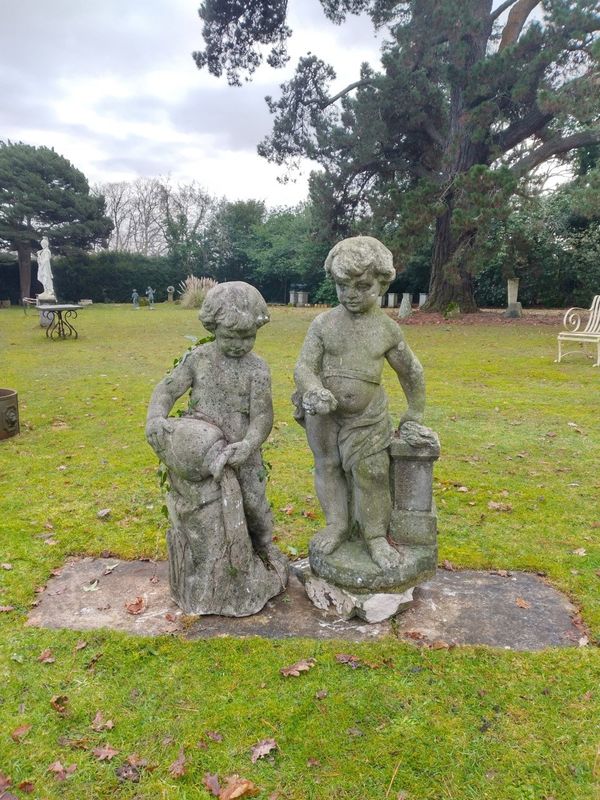 A pair of composition stone putti