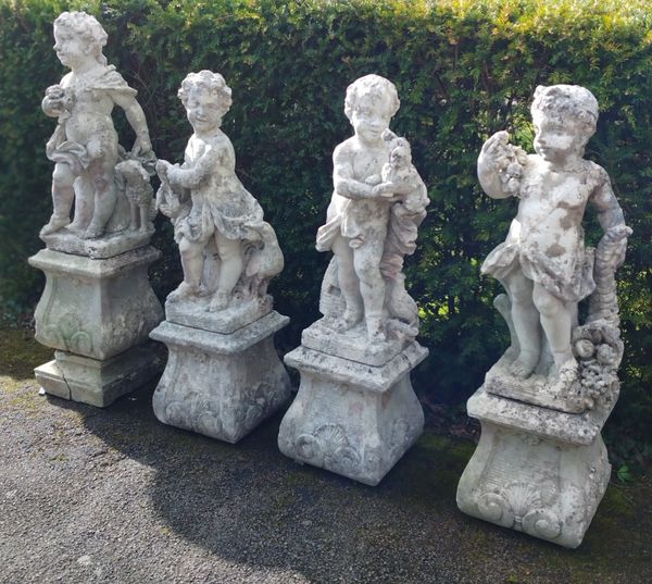 A set of four carved limestone allegorical figures of putti on pedestals