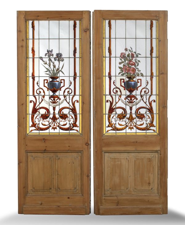 A pair of pine doors set with stained glass panels