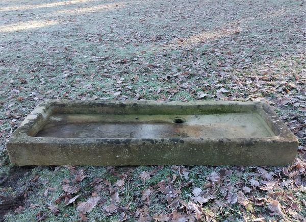 A shallow rectangular carved stone trough