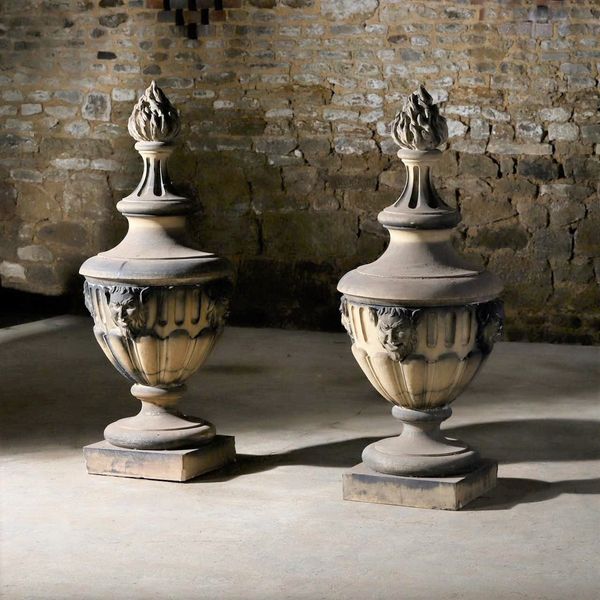 A substantial pair of stoneware lidded urns