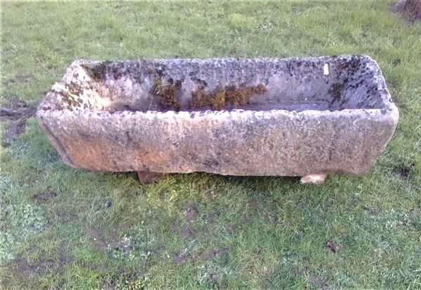 A rectangular carved limestone trough