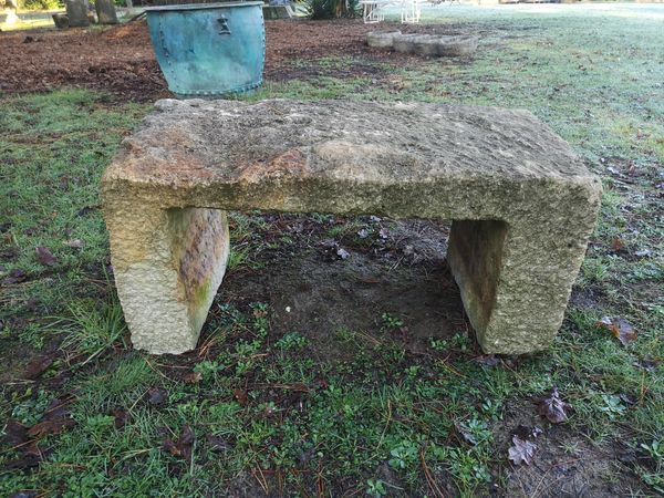 A rustic carved stone bench