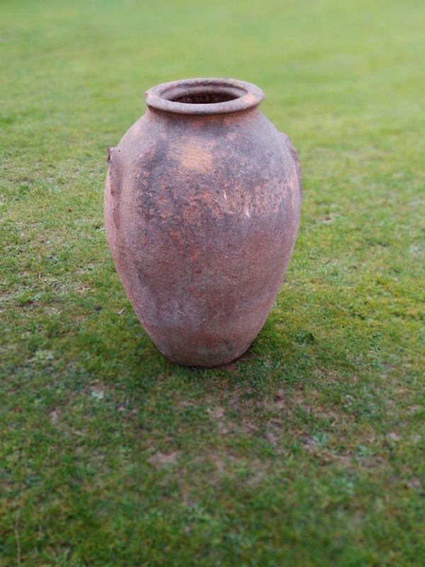 A terracotta oil storage jar