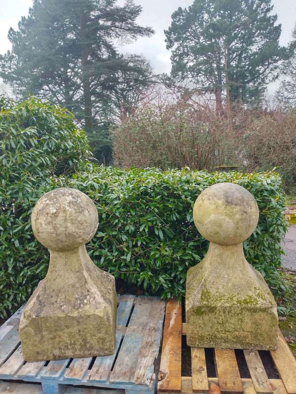 A pair of   large carved limestone gate pier balls