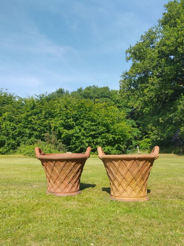 A pair of terracotta basket weave planters