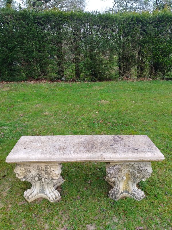 A composition stone bench and a pair of stools