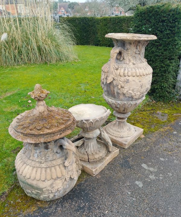 A pair of Swedish style composition stone lidded urns