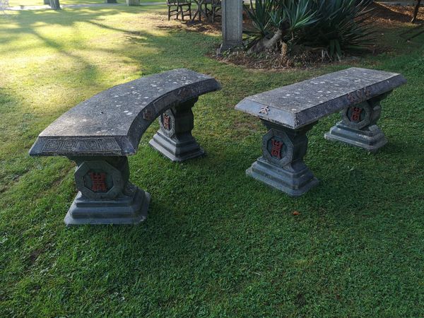 Two Oriental style composition stone curved benches