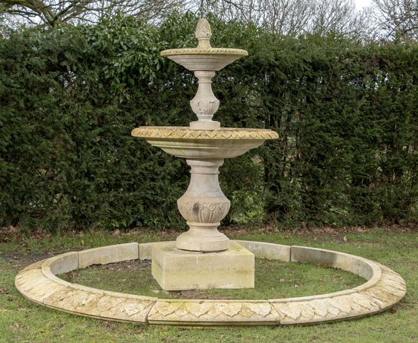 A composition stone two tier fountain and surround