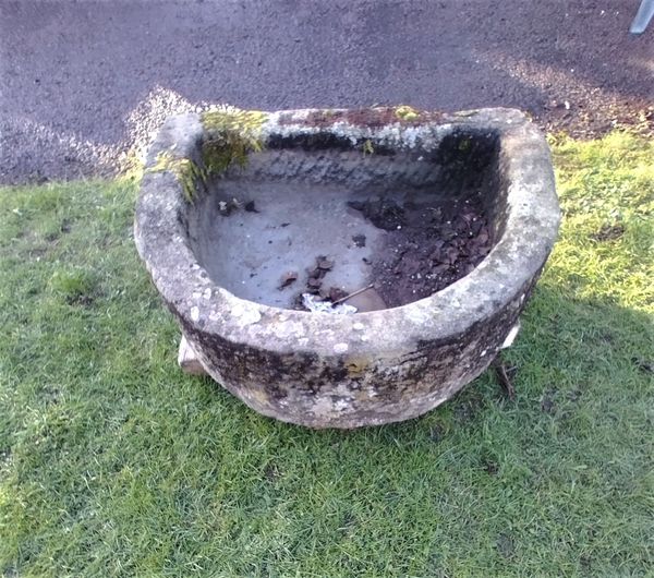 A carved sandstone D shaped trough