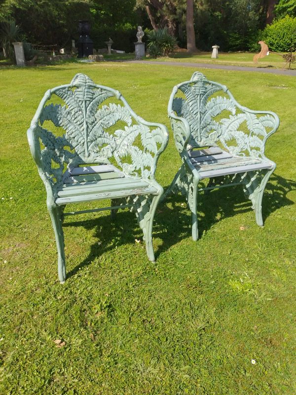 A pair of Coalbrookdale Fern and Blackberry pattern cast iron chairs