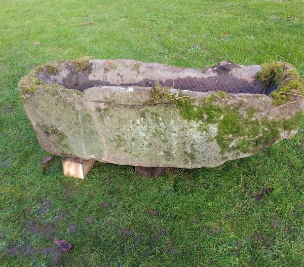 A rectangular carved stone trough