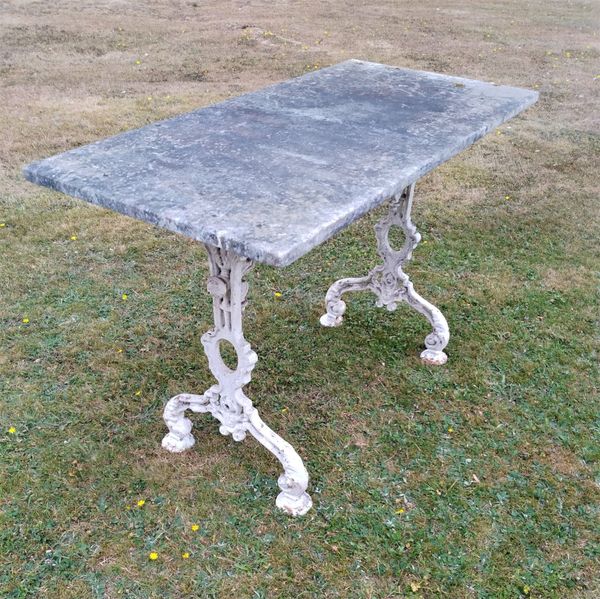 A cast iron table  with marble top