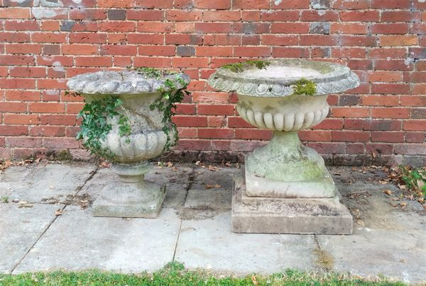 Two composition stone urns