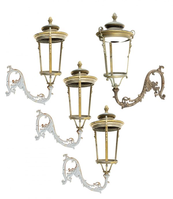 A pair of impressive brass/bronze wall lanterns with cast iron brackets