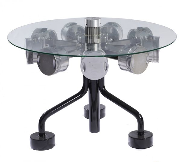 A circular topped table incorporating 1930's aircraft pistons