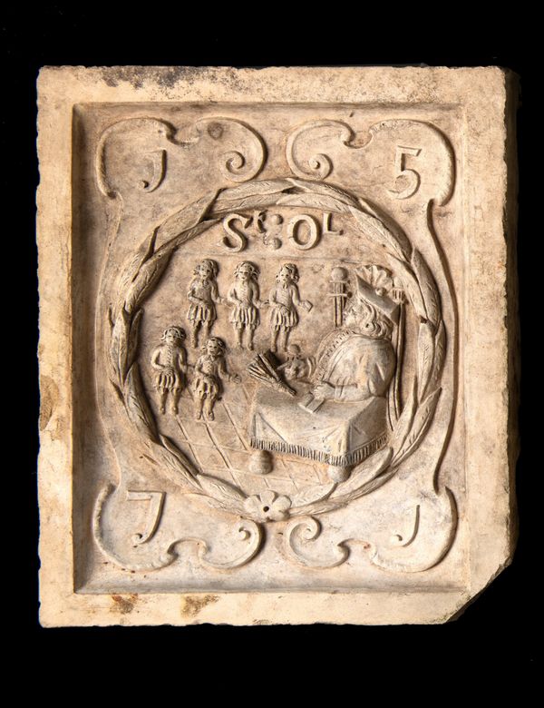 A Coade stone boundary marker plaque depicting the seal of St Olave's school and its foundation date 1571
