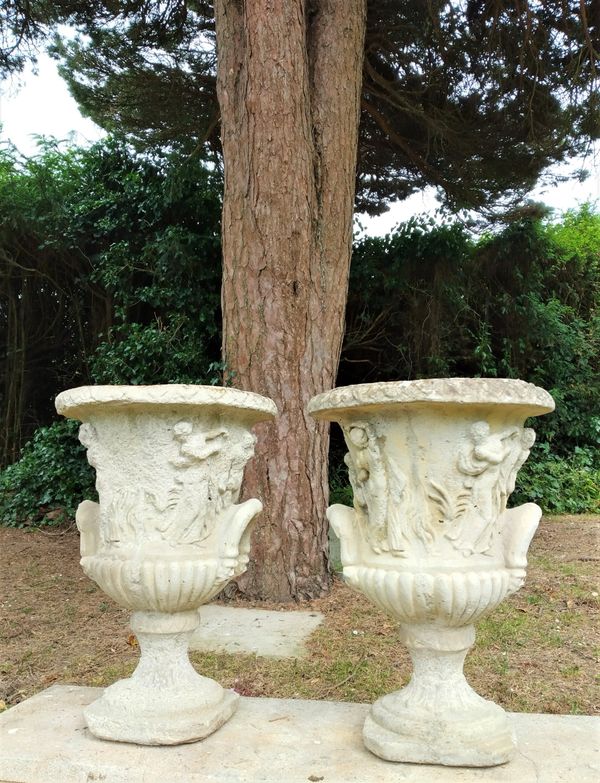 A pair of composition stone urns