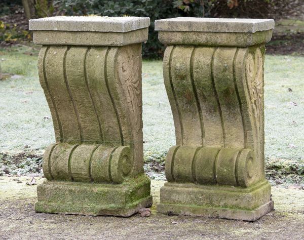 † A pair of carved sandstone wall consoles