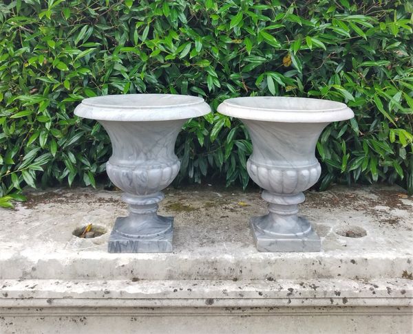 A pair of grey veined marble urns
