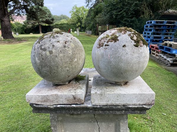 A pair of composition stone gate pier balls