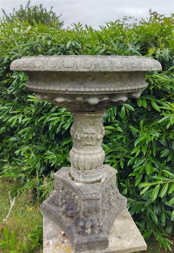 A carved white marble bowl on stand