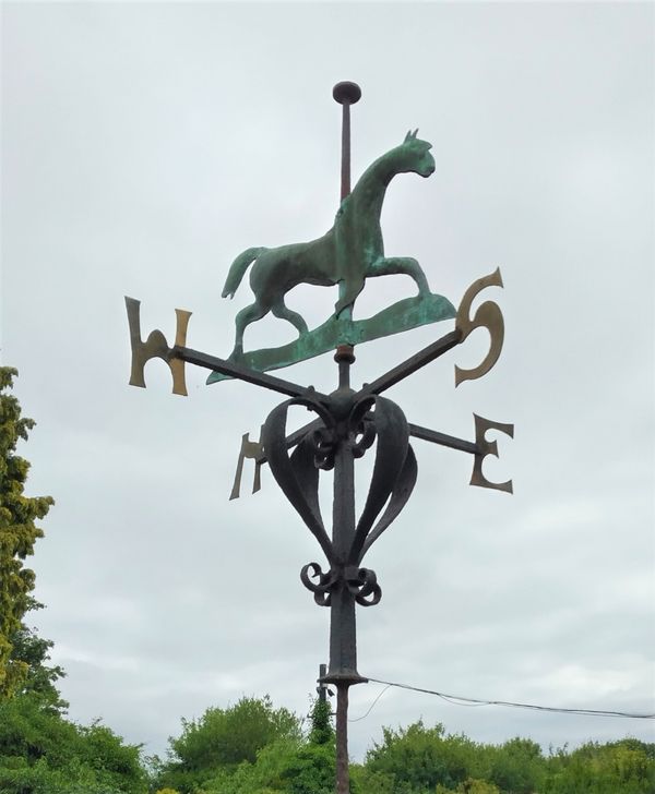 A wrought iron and copper weathervane