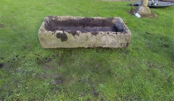 A  rectangular carved stone trough