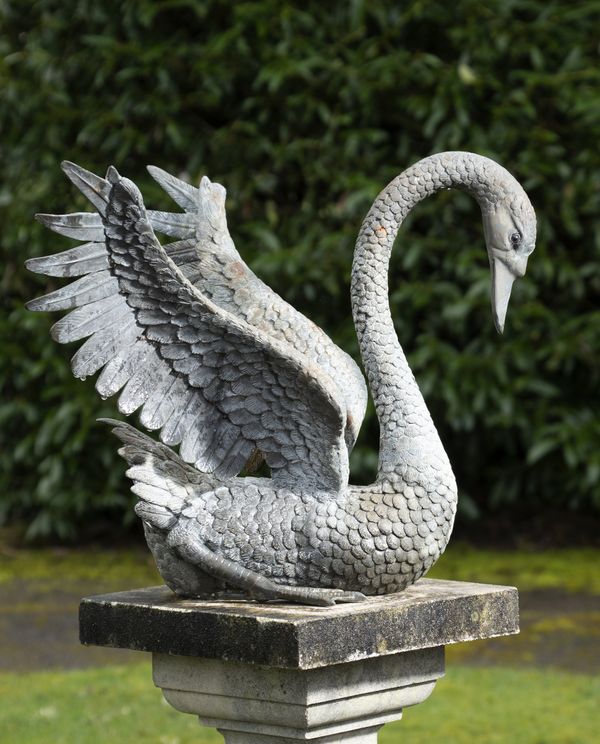 A bronze swan on composition stone pedestal