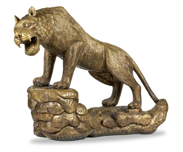 An impressive gilded carved wood stylised lion