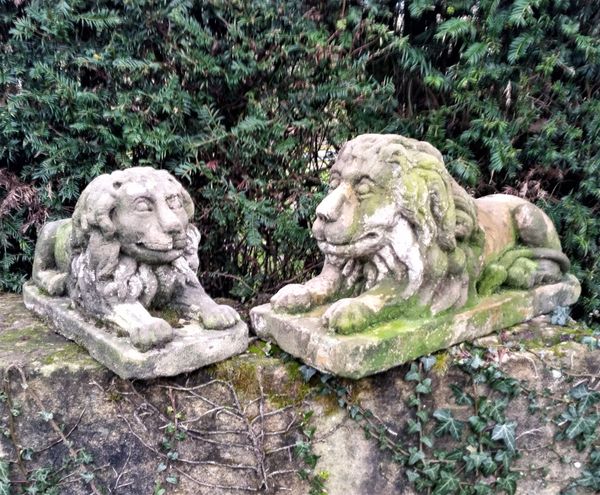 Two similar carved sandstone lions