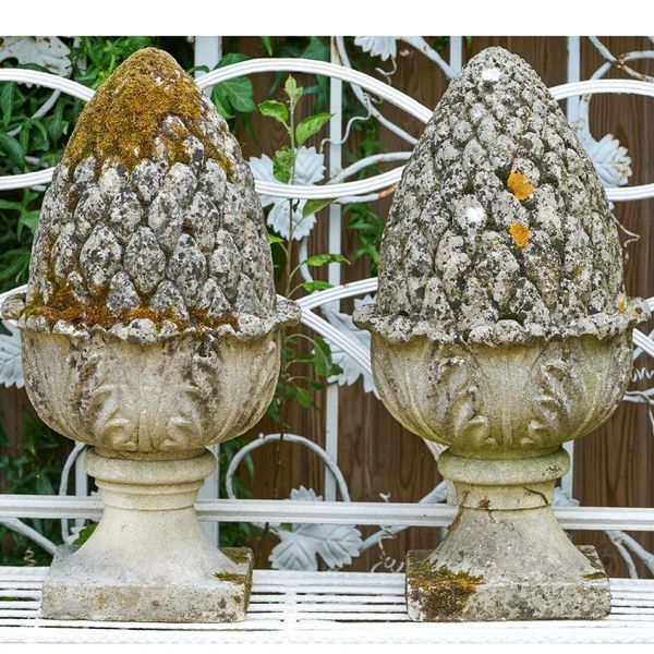 A pair of  carved limestone pineapple finials