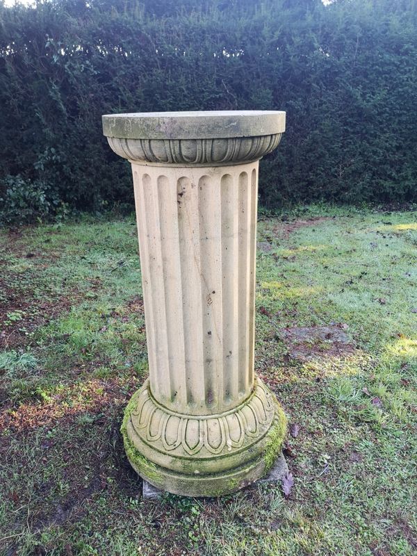 † A substantial carved sandstone column pedestal