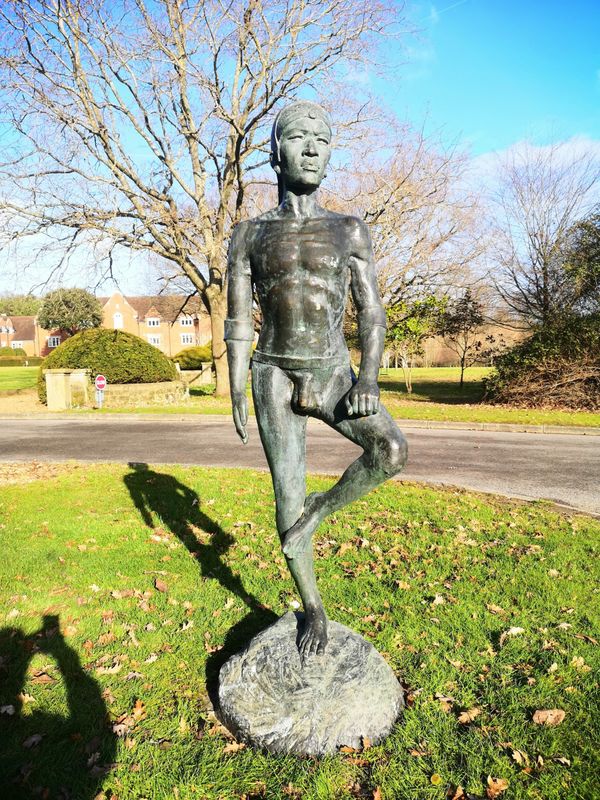 A bronze figure of a naked Zulu man
