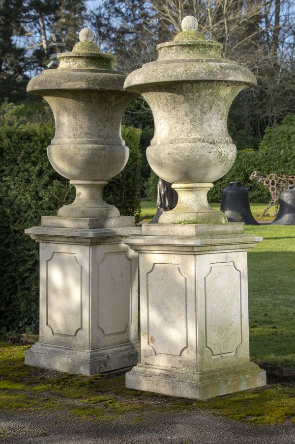 A pair of large carved Vicenza stone finials on plinths