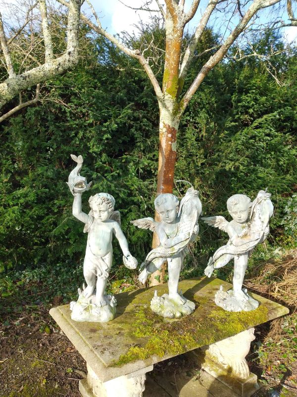 A group of three bronze cherub fountains