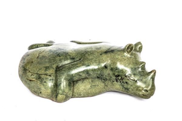 Sylvester Mubayi Resting Rhino Lemon Opal Stone Signed 27cm high by 58cm wide by 70cm deep Born in 1942 in the Chiota Reserve, near Marondera. After...