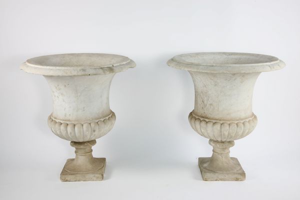 A pair of large carved white marble urns