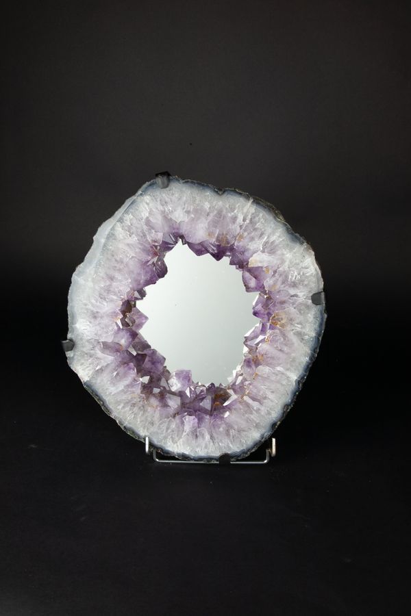 An amethyst geode mirror with hanging bracket