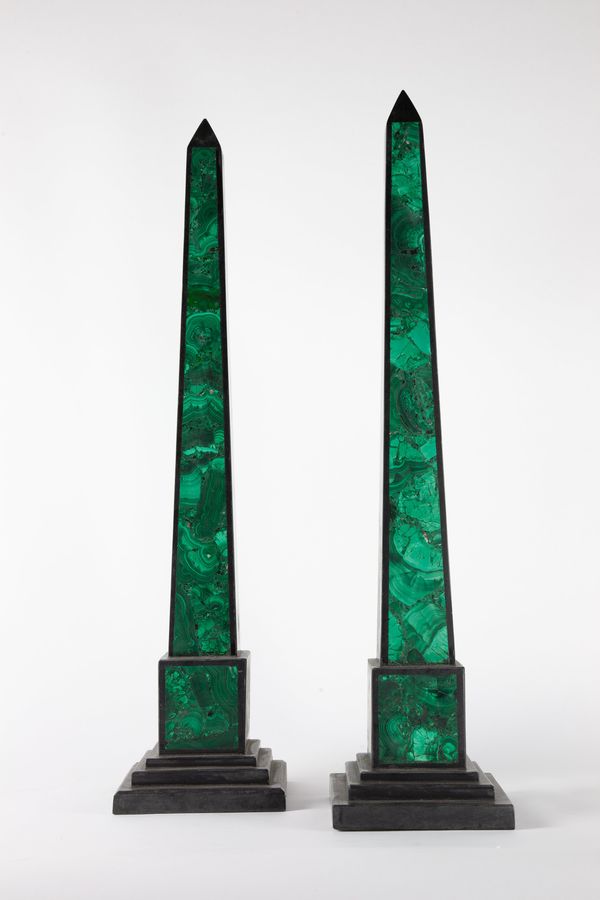 A pair of black marble and malachite veneered obelisks