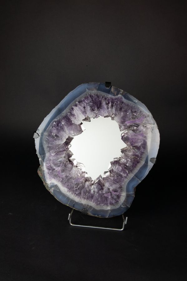 An amethyst geode mirror with hanging bracket