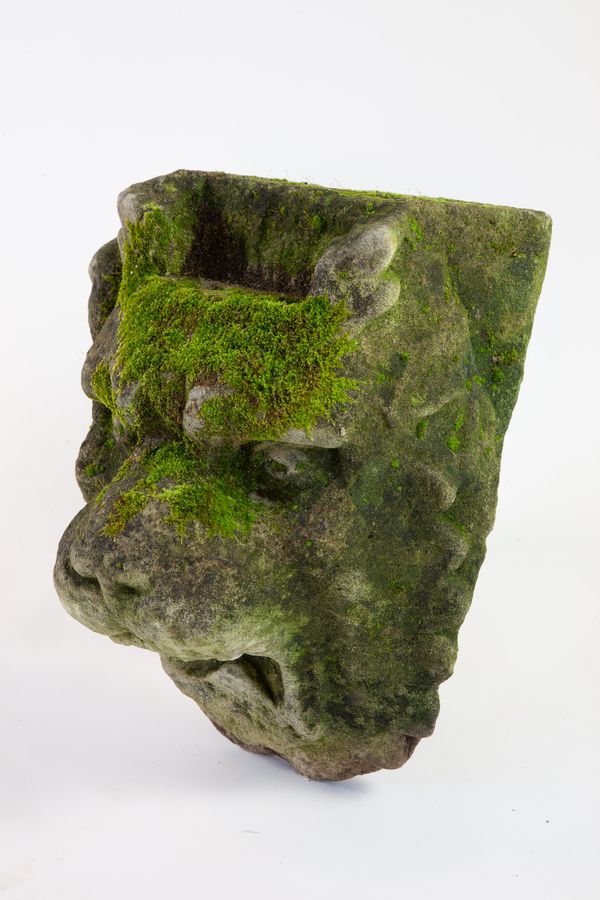 A carved stone lion fountain mask