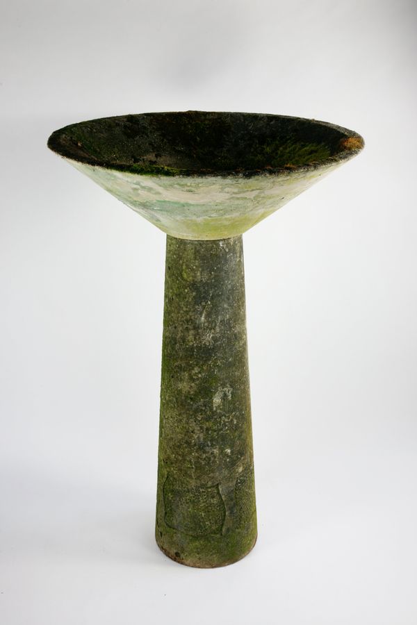 A carved stone bowl on stand