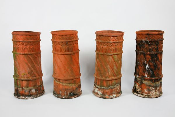 A set of four terracotta chimney stacks