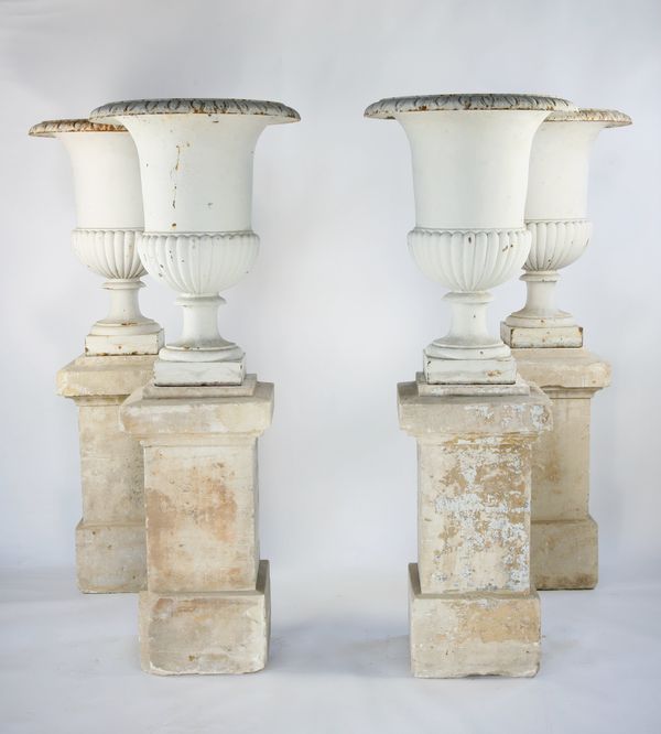 A set of four large cast iron urns