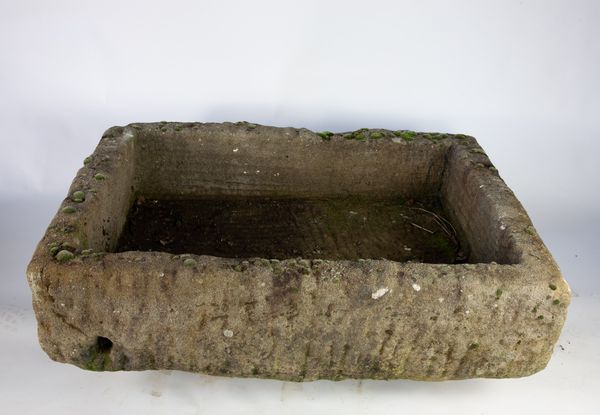 A large carved gritstone trough