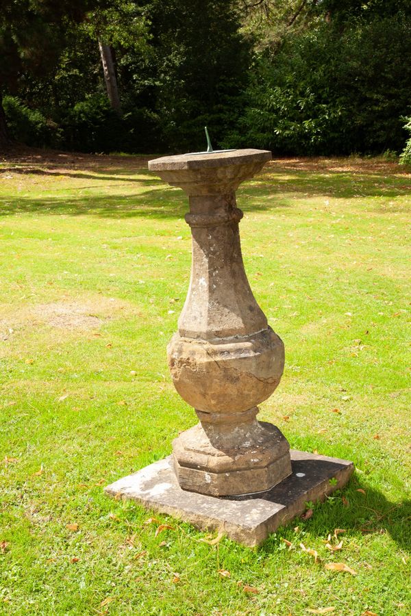 An Edwardian carved sandstone sundial with circular bronze plate